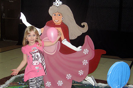 Little Girl Standing in Front of Candy Land Prince